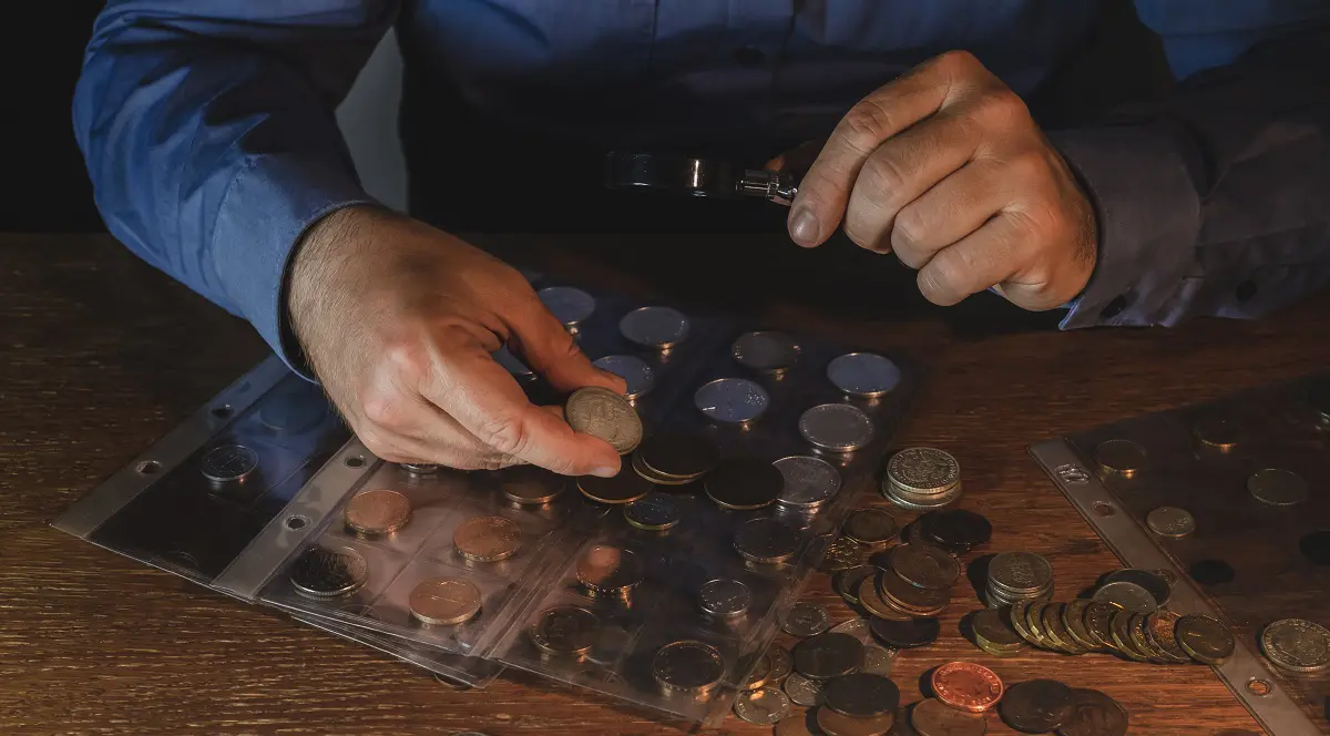 Coins grading is the process of evaluating a coin’s authenticity and condition, then sealing it in a protective holder (called a slab) with a standardized grade assigned by a recognized service like PCGS or NGC.
That little label carries a lot of weight. Buyers trust it because it removes uncertainty. A coin graded and certified by an established company usually sells faster, for a stronger price, and with less debate about value.