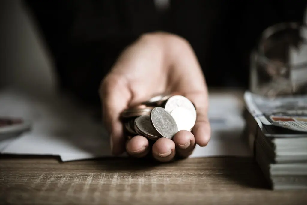 Silver coins in hands