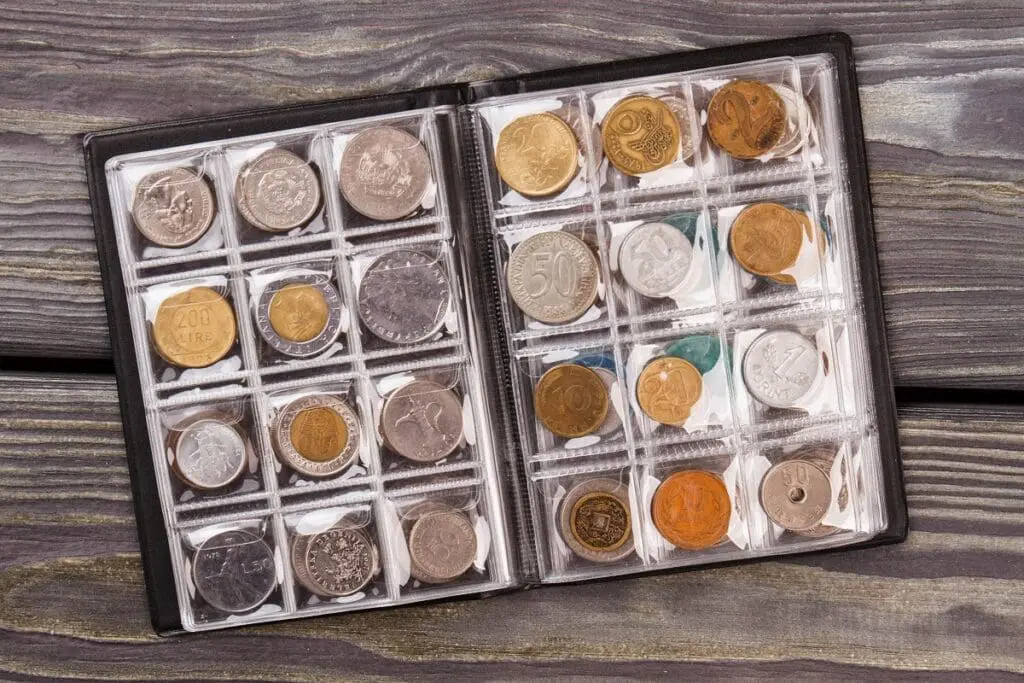 Coins collection on wooden desk.